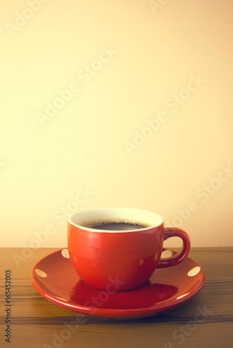 red hot coffee cup on orange wood table