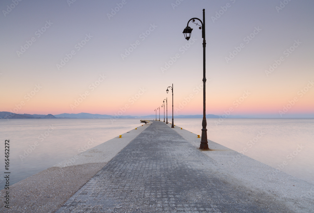 Sunset at a pier in the harbor of Kos town, Greece.
