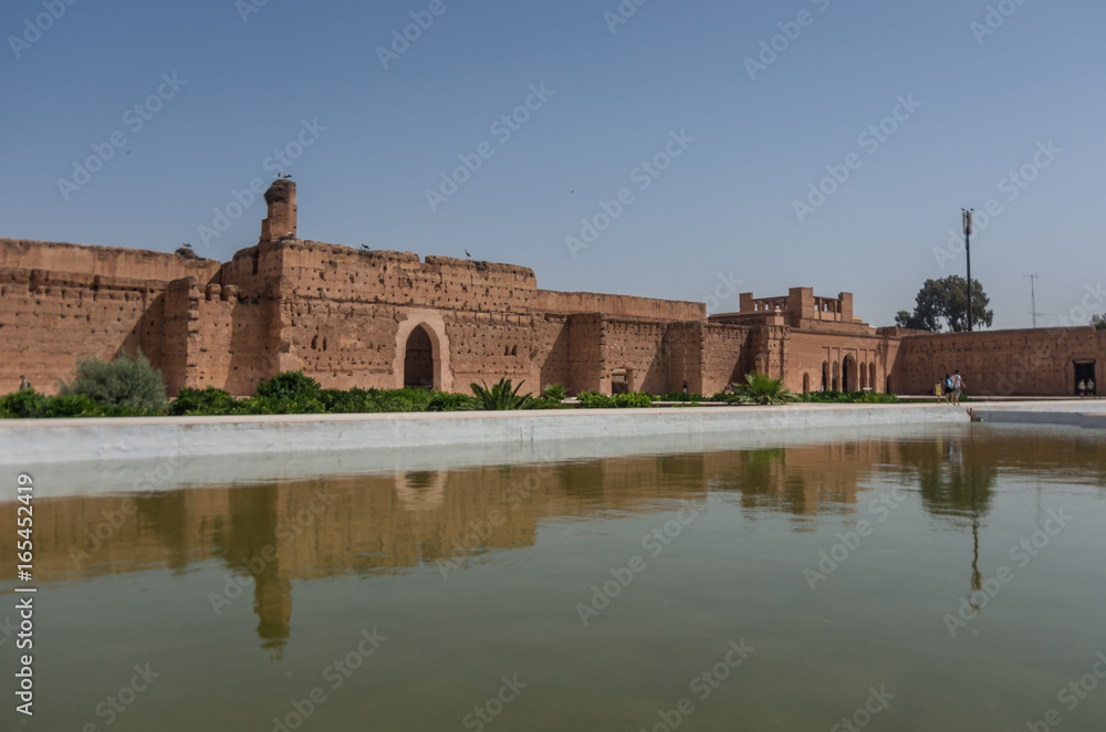 Wall's reflection in pool of El Badi Palace or Palais El Badii in Marrakech, Morocco