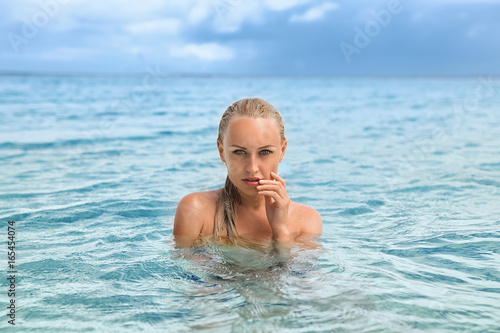 Beautiful blonde mermaid emerged from the water.