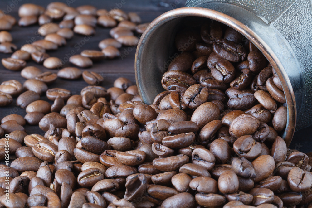 Fototapeta premium coffee beans roasted isolated on wooden background close up cut out in cup