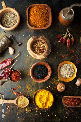 Spices, herbs and condiments on a table in a spoon