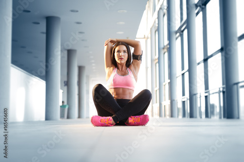 Young athletic woman stretching before running exercise