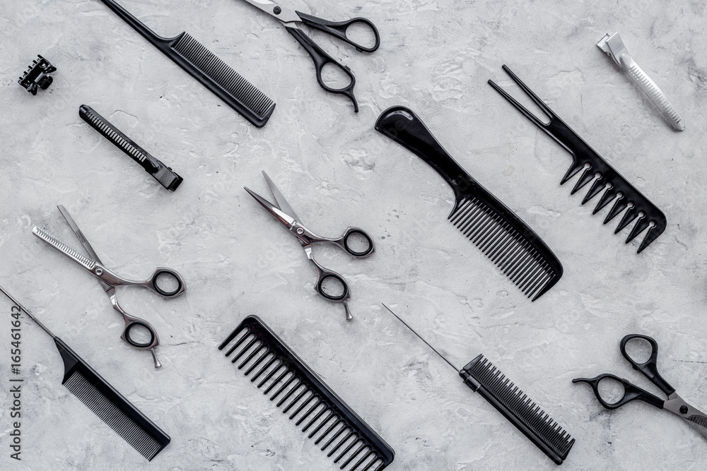Pattern of combs and hairdresser tools on grey table background top view Pattern of combs and hairdresser tools on grey table background top view