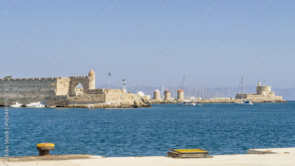 Beautiful view of the ancient port of Rhodes with the windmills and Fort of St. Nicholas, Rhodes island, Greece Beautiful view of the ancient port of Rhodes with the windmills and Fort of St. Nicholas, Rhodes island, Greece