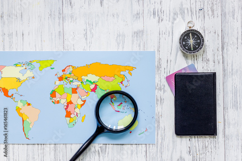Planning trip. World map, bank card and compass on wooden table background top view copyspace