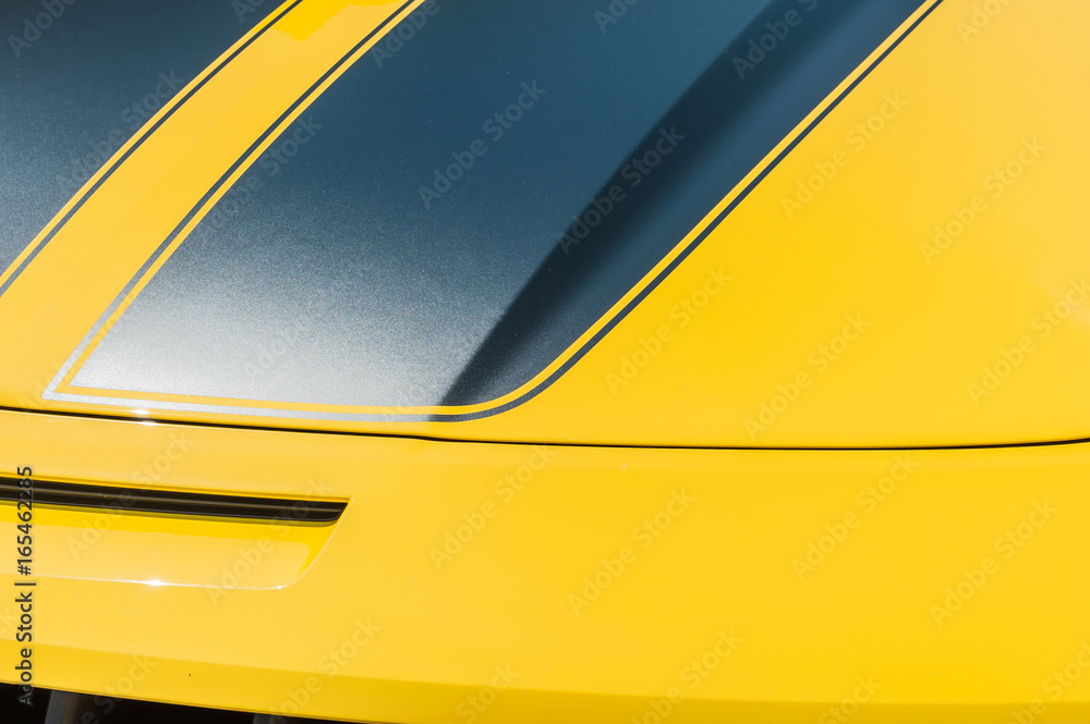 Close up of hood of a yellow sport car