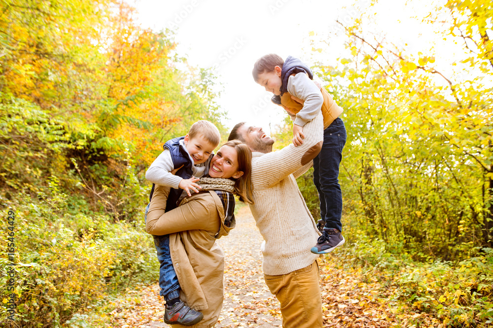 Beautiful young family on a walk in autumn forest. Beautiful young family on a walk in autumn forest.