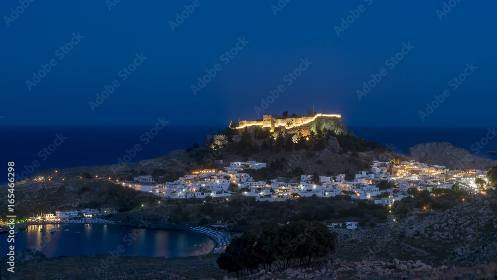 The Acropolis of Lindos, Rhodes Island, Greece, illuminated at the blue hour of twilight