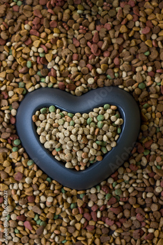 Heart bowl filled by dry pet food