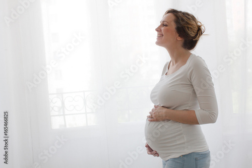 Pregnant happy woman touching belly and laughing Free Download Pregnant happy woman touching belly and laughing - GFXLoad
