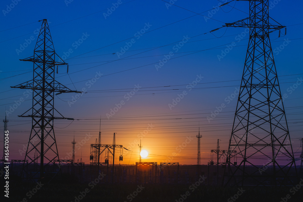 Fototapeta premium high-voltage power lines at sunset.