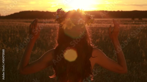 Calm woman holding flower wreath in twilight time photo