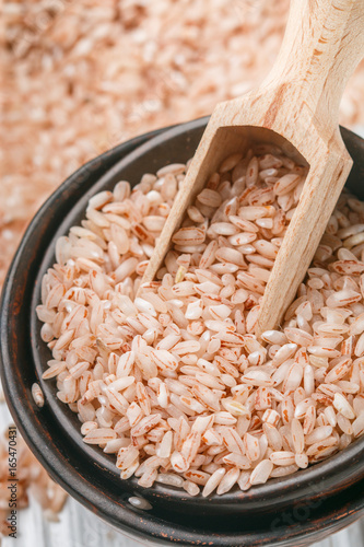 Raw Organic Devzira Rice on a white table closeup photo