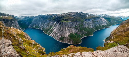 Panoramic aerial wide angle landscape from mountain viewpoint with clouds in cliff during trip Norway.. High resolution panorama, Norway. Trolltunga hiking route.