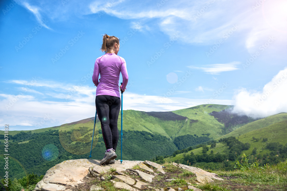 Young woman hiking in the mountains Young woman hiking in the mountains
