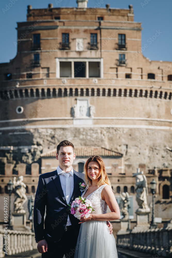 Portrait of bride and groom posing on the streets of Rome, Italy