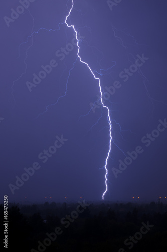Single lightning in stormy sky