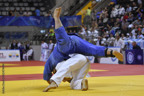 Male Judoka fighters during Judo competition 