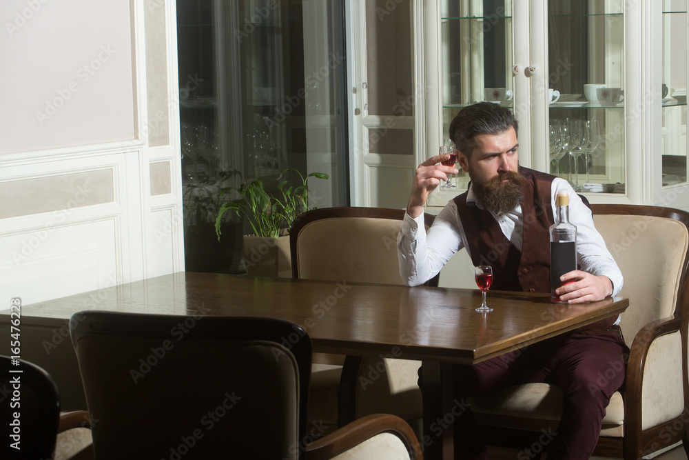 Hipster drinking wine served with two glasses Hipster drinking wine served with two glasses