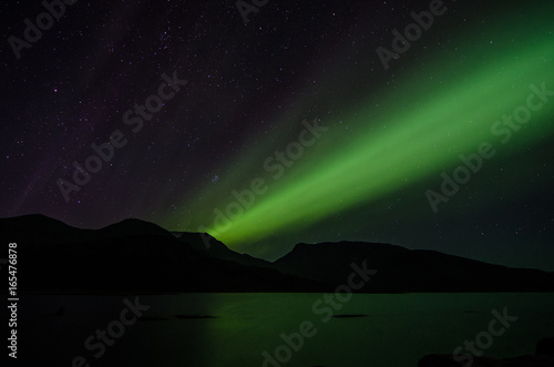 Northern lights at night over a lake in Igaliko © David