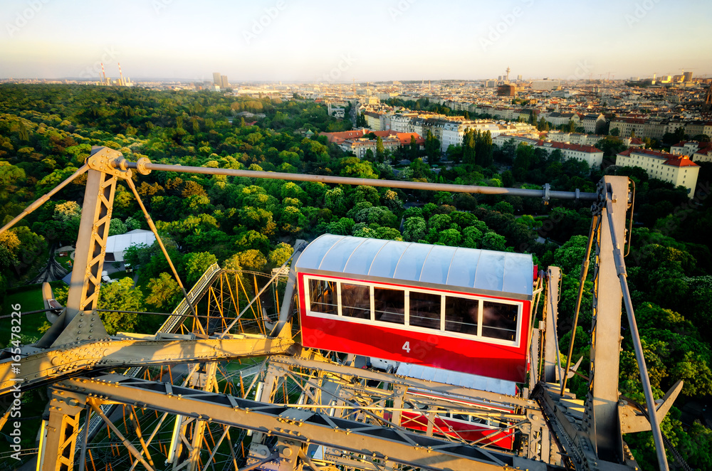 Naklejka premium Sunset panorama of Vienna from the famous Prater Riesenrad, old giant ferris wheel and famous landmark of the city