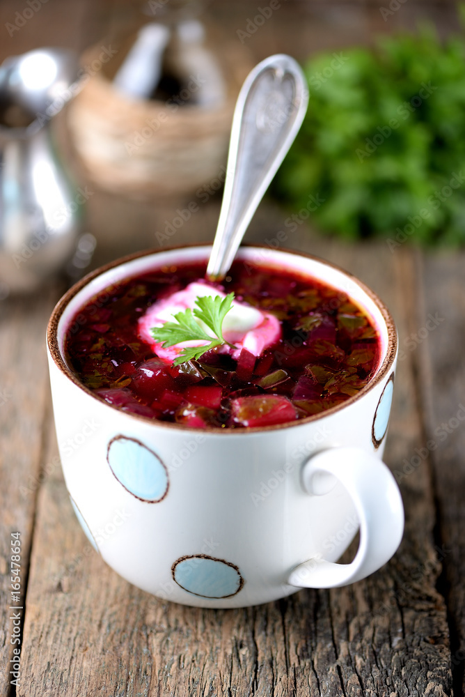 Traditional Ukrainian soup borsch on an old wooden background. Rustic style. Traditional Ukrainian soup borsch on an old wooden background. Rustic style.