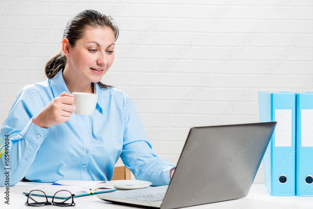 Portrait of a secretary with coffee at work Portrait of a secretary with coffee at work