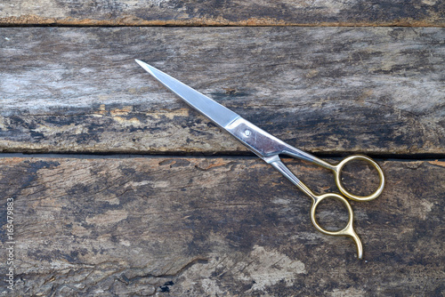 Professional hairdressing scissors isolated on wooden