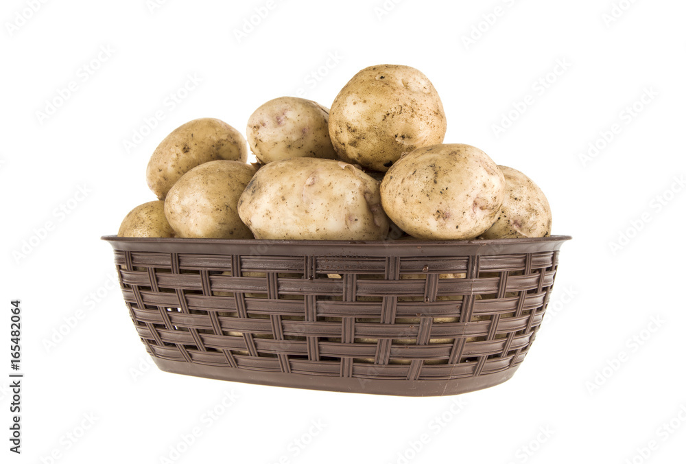 Young potatoes in a basket on a white background Young potatoes in a basket on a white background