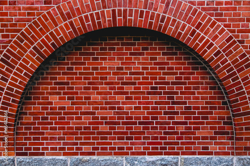 Arch od red brick wall artistic background, regular texture
