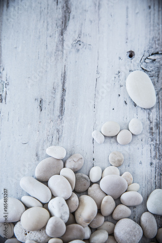 White pebbles minimalistic composition /  Rustic wooden background