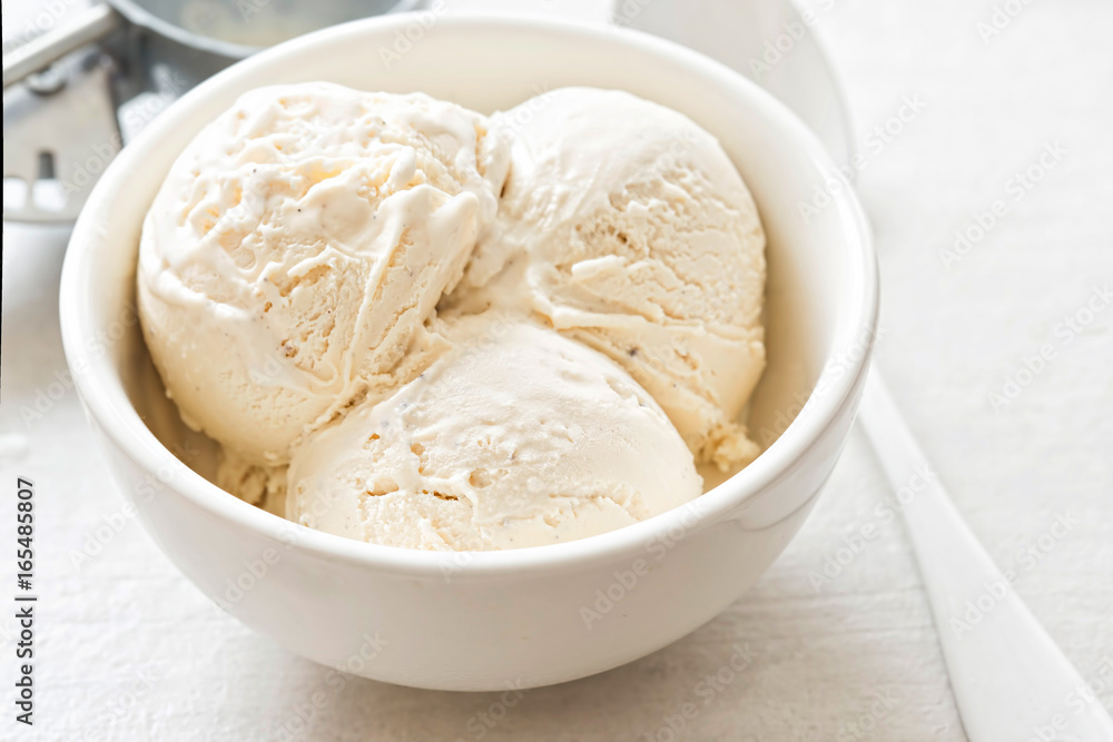 Vanilla ice cream scoops in white bowl Vanilla ice cream scoops in white bowl