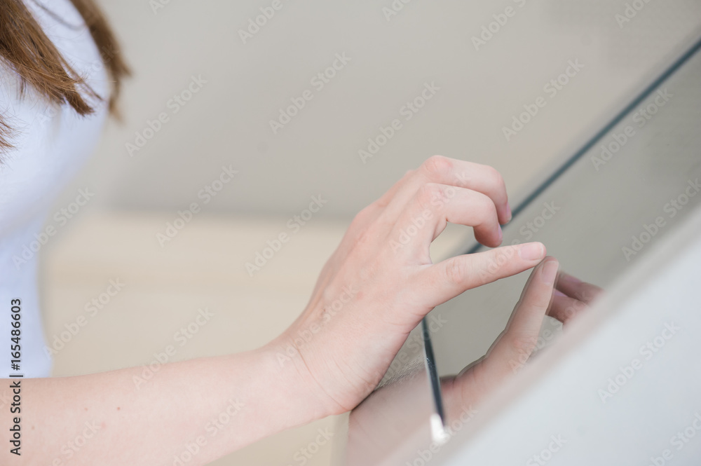 The woman presses the touchpad on the device
