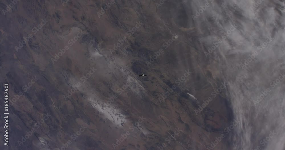 Satellite in distance travels over Earth Satellite in distance travels over Earth
