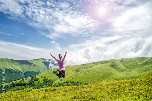 Young woman jumping in the mountains