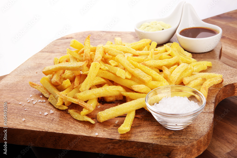 Close up Crispy Potato Fries with Two Dipping Sauce, Served on Rustic Wooden Table Close up Crispy Potato Fries with Two Dipping Sauce, Served on Rustic Wooden Table