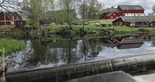 Swedish red iconic houses by stream time-lapse photo