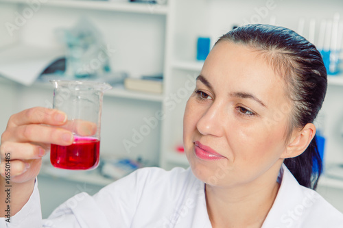 Young female scientist in lab   doing experiments in lab.