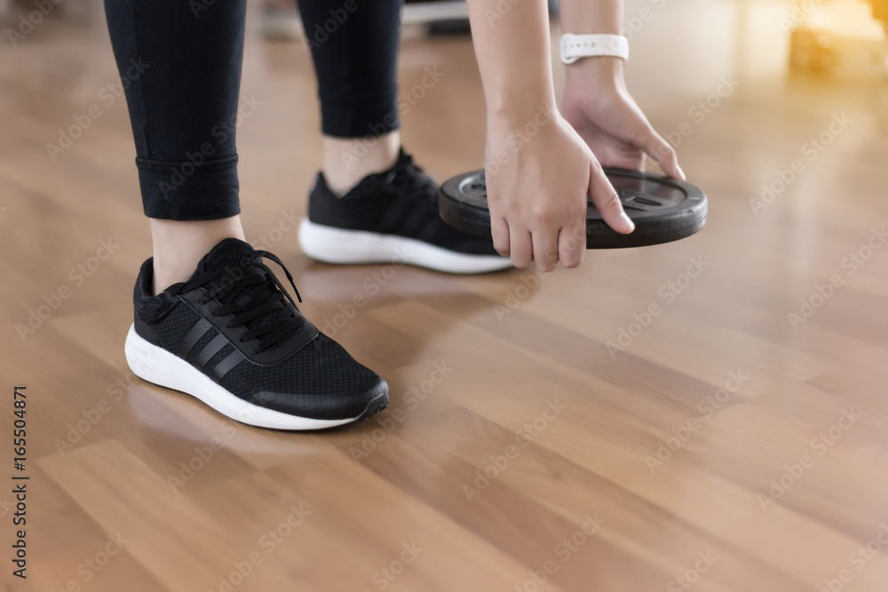 woman fitness workout use dumbbell in Closeup on fitness training Strong Female fitness exercise concept woman fitness workout use dumbbell in Closeup on fitness training Strong Female fitness exercise concept