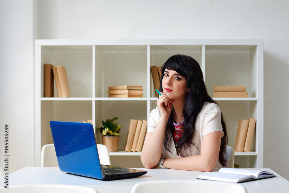 business woman working with laptop sitting at Desk in the office or classroom business woman working with laptop sitting at Desk in the office or classroom