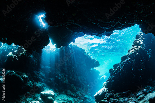 Rays of sunlight into the underwater cave 
