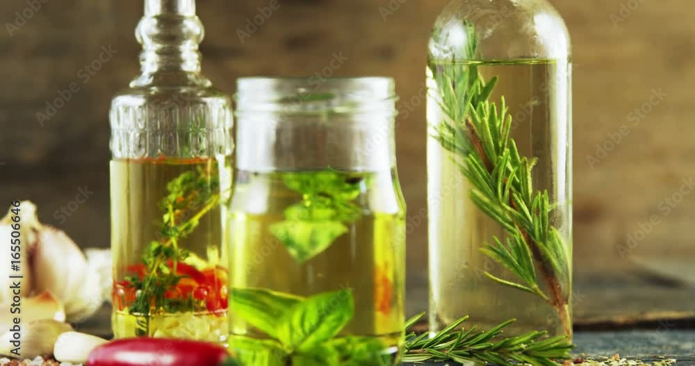 Jars and bottles with olive oil and herbs Jars and bottles with olive oil and herbs