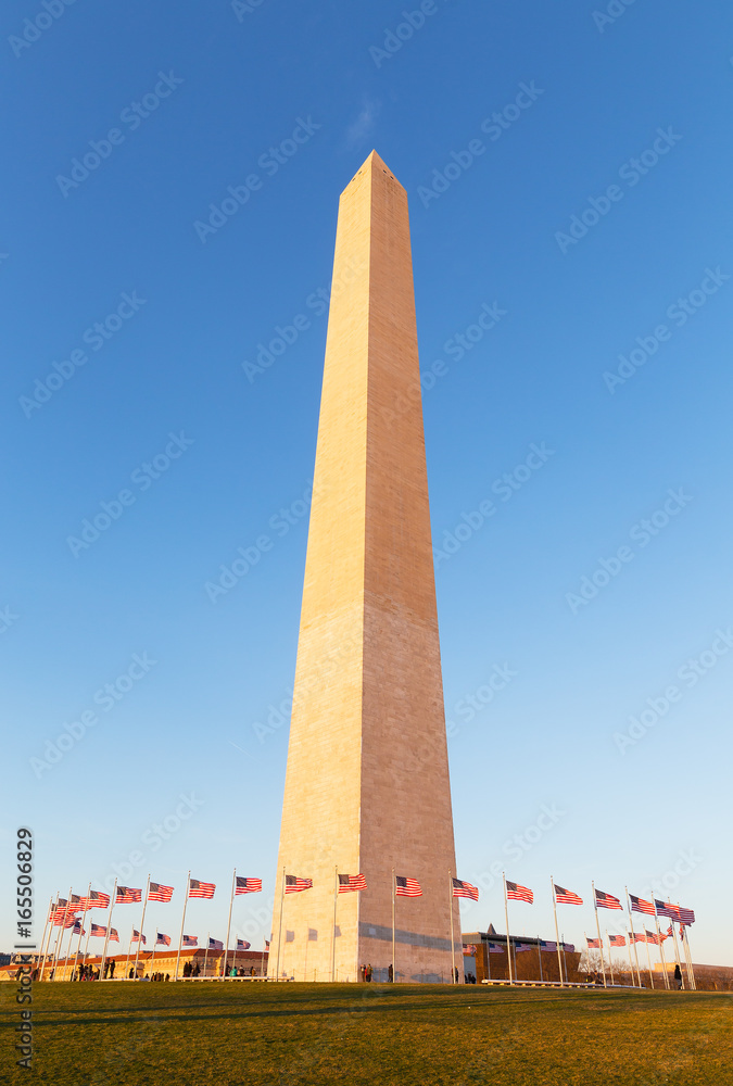 Washington Monument in US capital city before sunset. The famous obelisk of Washington DC against a blue sky.