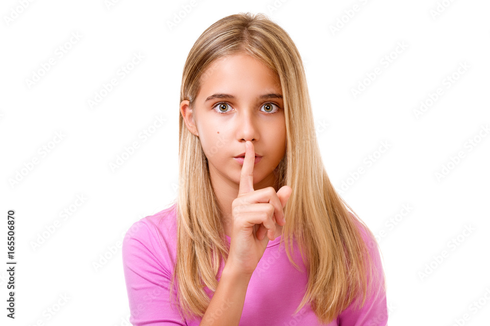 Young girl with finger on lips as concept of ordering silence.Isolated Young girl with finger on lips as concept of ordering silence.Isolated