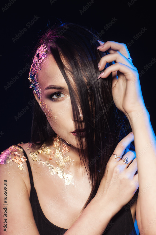 Fototapeta premium Portrait of a girl on a black background