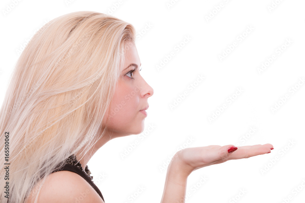 Blonde woman sending air kiss on palm hand