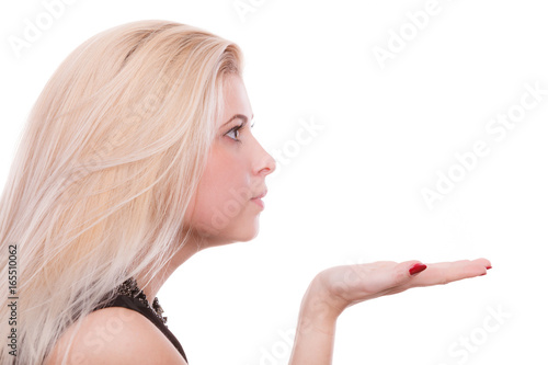 Blonde woman sending air kiss on palm hand
