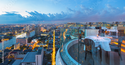 Photography Dining table with beautiful city view on rooftop at twilight scene