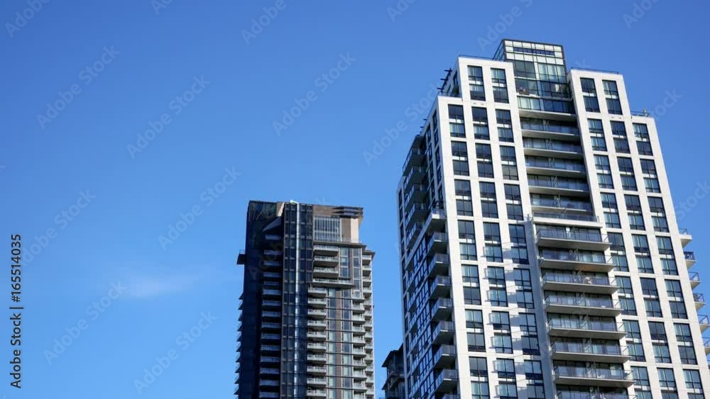 Motion of high-rise residential new buildings on blue sky with 4k resolution Motion of high-rise residential new buildings on blue sky with 4k resolution